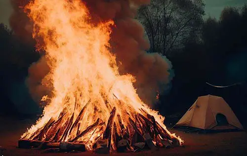 big camp fire next to tent