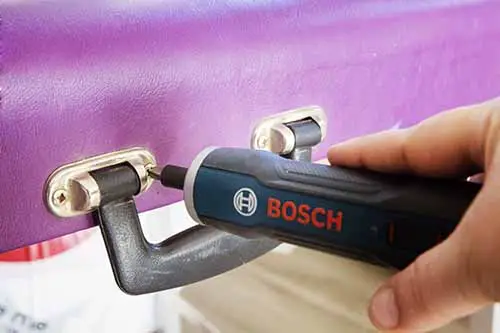 Bosch Go fixing loose screw on a massage table.
