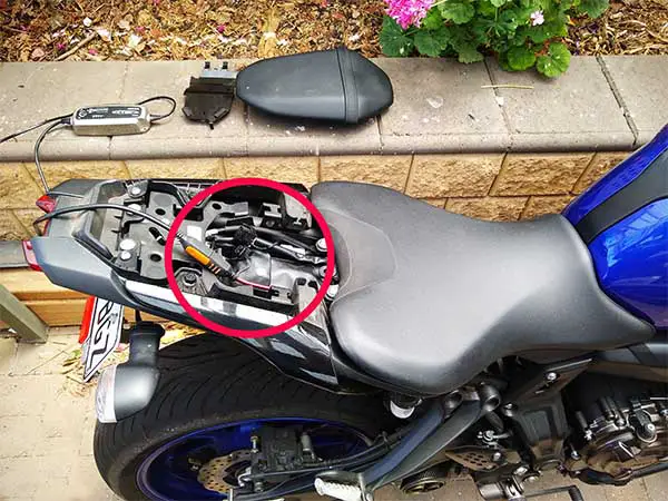 Can you charge a motorcycle battery while still connected